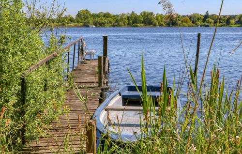 a boat is docked next to a dock on a lake at Ferienwohnung Jabel in Jabel
