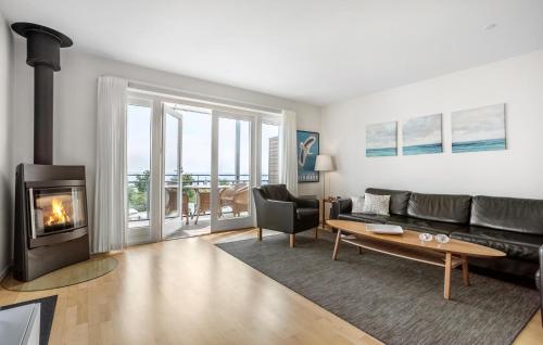 a living room with a couch and a fireplace at Amazing Apartment In Gudhjem With Wifi in Gudhjem