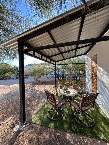 a patio with a table and chairs under awning at Casita Palo Verde in San José del Cabo