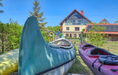 two kayaks are parked in front of a house at Ferienwohnung Mirow in Mirow
