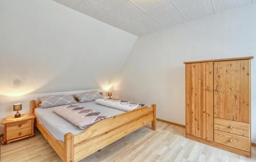 a bedroom with a wooden bed and a wooden cabinet at Ferienwohnung Blankensee in Blankensee