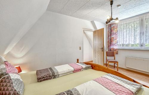 a bedroom with two beds and a window at Ferienwohnung Blankensee in Blankensee