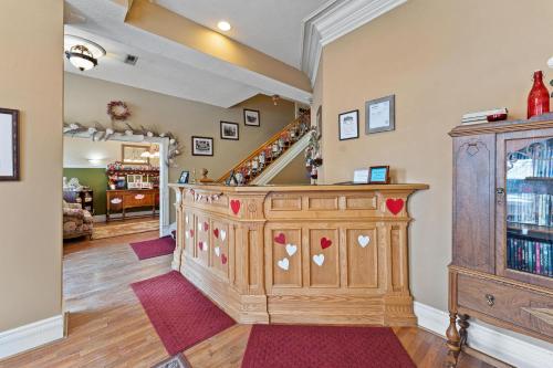 a room with a large wooden cabinet and a staircase at The Anniversary Inn - Logan in Logan