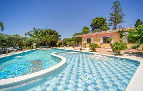 a swimming pool in front of a house at Villa Gaia in Menfi