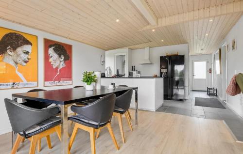 a kitchen and dining room with a table and chairs at 3 Bedroom Stunning Home In Hejls in Hejls