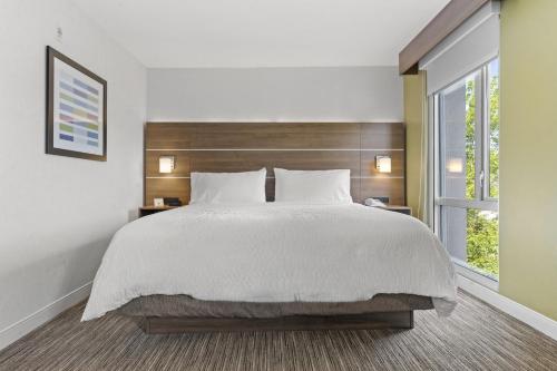 a bedroom with a large bed and a window at Holiday Inn Express and Suites Surrey by IHG in Surrey