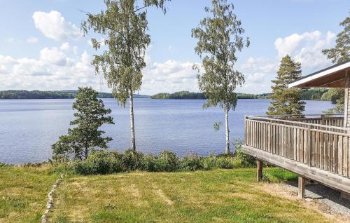 a house with a deck and a view of a lake at Beautiful Home In Dalslånged With Wifi in Dals Långed