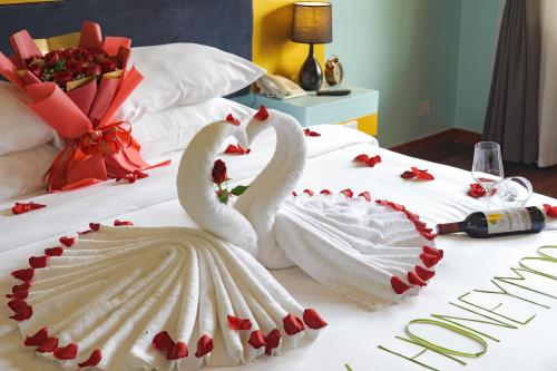 two swans in a wedding dress on a bed at Sala Siem Reap Resort in Siem Reap