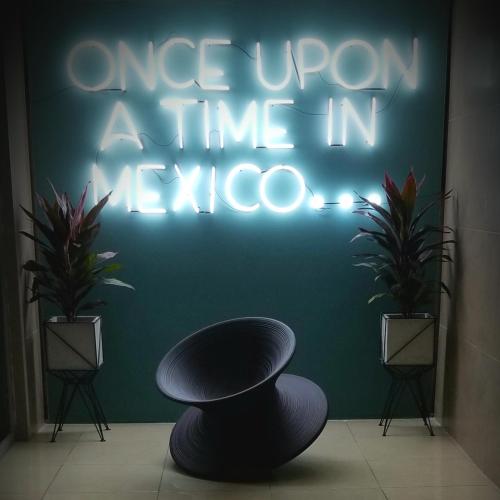 a neon sign that says once upon a time in argos at Wanderlust District in Mexico City