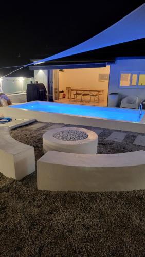 a room with a stage with a table and a bench at Ido Stay in Samcheok