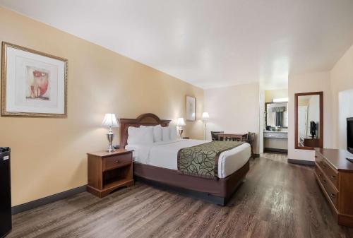 a hotel room with a bed and a television at SureStay Hotel by Best Western Fernley in Fernley