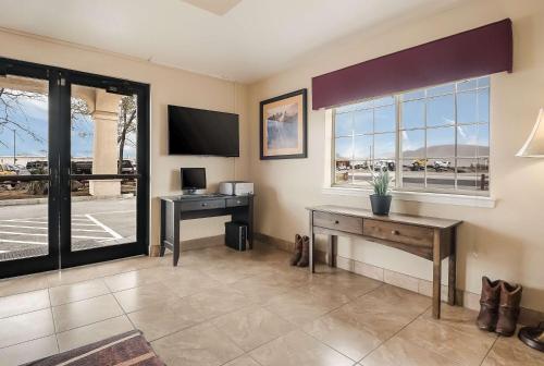 a living room with a desk and a window at SureStay Hotel by Best Western Fernley in Fernley
