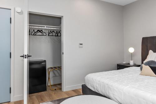 a bedroom with a bed and a door with a window at Group-Perfect - 3 Private Suites Downtown in Grand Rapids