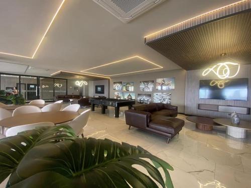 a living room with a couch and a piano at Dpto Home Office - Smart - Piscina - Cowork - Gym in Santa Cruz de la Sierra