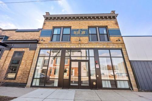 a brick building with the entrance to a building mi at Stylish Dual King Suites - Walk to Bridge St in Grand Rapids