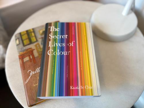 a book entitled the secret lives of colour sitting on a table at Welcome to The Roy - Family home close to airport and train! in Melbourne