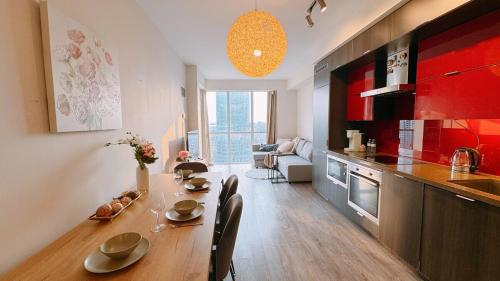 a kitchen with a table and chairs in a room at Luxury 1 BR and Den Near CN Tower in Toronto