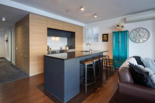 a kitchen with a large island with a counter at Marina Apartments - Element Escapes in Queenstown