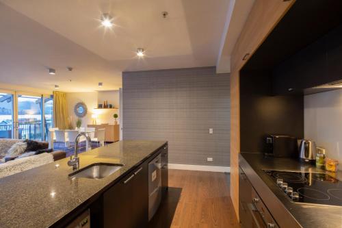 a kitchen with a sink and a counter top at Marina Apartments - Element Escapes in Queenstown