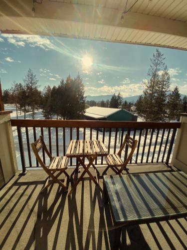 a wooden table and bench on a balcony at Sable Ridge Retreat in Radium Hot Springs