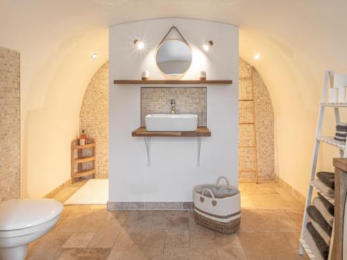 a bathroom with a white sink and a toilet at Maison rénovée au bord de l'Ognon avec grand jardin et plage privée - FR-1-583-395 in Cenans
