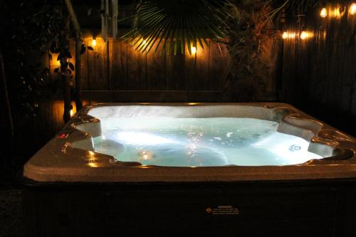 a jacuzzi tub in a dark room with lights at Beautiful home with short stroll to Havelock Village in Havelock North
