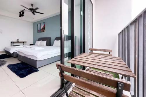 a bedroom with a bed and a wooden bench at I-City Luxury Condominiums, Shah Alam by Smarthome in Shah Alam