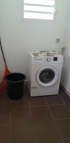 a washing machine sitting on the floor in a room at Lifou Xepenehe in Chépénéhé