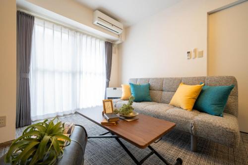 a living room with a couch and a table at MP STYLE SAPPORO-35 in Minami-jūichijō