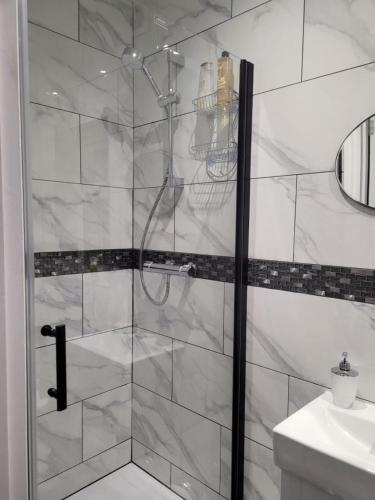 a shower with a glass door in a bathroom at Boardlands House 3 Bed home in Southampton