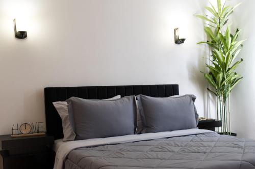 a bedroom with a bed with two plants at 2BR Near OHare and Transit Newly Furnished Modern in Chicago