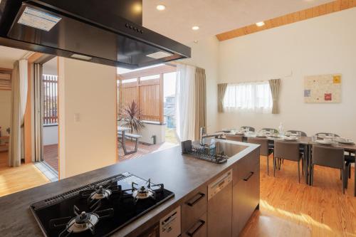 a kitchen with a stove and a counter top at Nicostay Katsuura Beach in Fukuoka