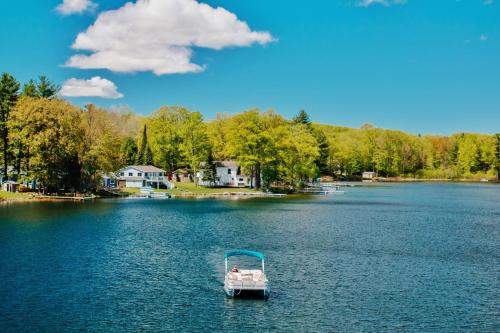 a boat in the water on a lake at Serenity Shores 5BD Hot Tub Fishing Hiking in Traverse City