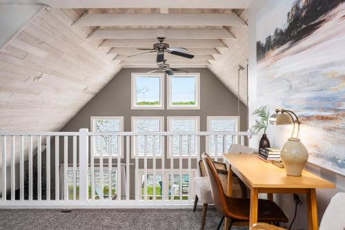 a dining room with a table and a ceiling fan at Serenity Shores 5BD Hot Tub Fishing Hiking in Traverse City