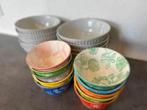 three stacks of bowls sitting on a table at Nicostay Katsuura Beach in Fukuoka