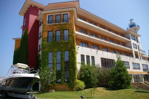 a building with a boat parked in front of it at Visit Sunny Beach Marina Apartments in Ravda