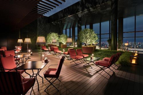 a room with chairs and tables in a building at Bvlgari Hotel Tokyo in Tokyo