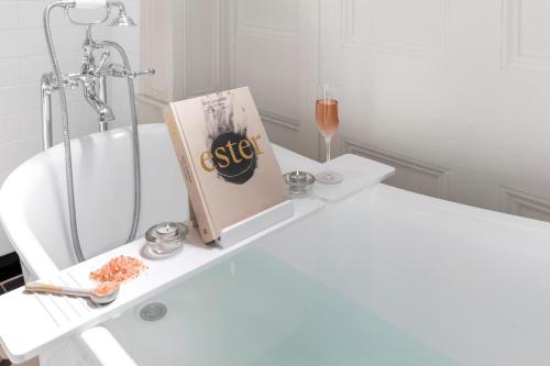 a book sitting on a table next to a bath tub at Marnong Estate in Mickleham