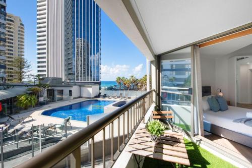a balcony with a swimming pool and a view of the city at Unbeatable Location - Spacious 3 bedroom townhouse in Gold Coast