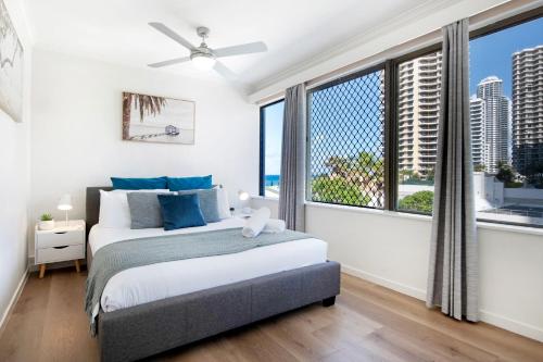 a bedroom with two beds and a large window at Unbeatable Location - Spacious 3 bedroom townhouse in Gold Coast