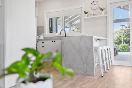 a kitchen with a sink and a counter top at Karapiro Cottage in Karapiro