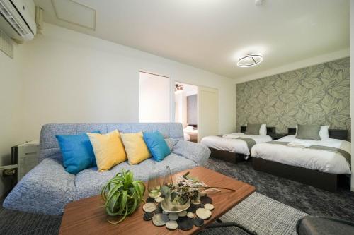 a living room with a couch and a bed at MP STYLE SAPPORO-35 in Minami-jūichijō