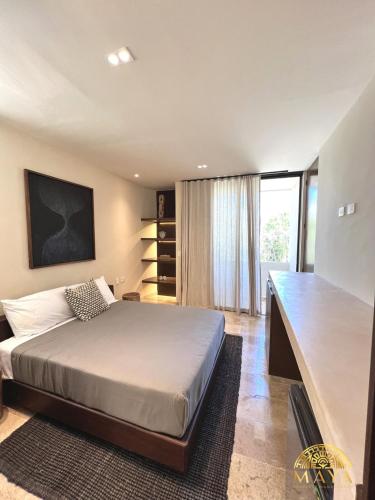 a bedroom with a bed and a large window at Peregrina Tulum 302A 2BR Luxury Condo in Tulum