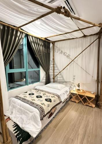 a bedroom with a bed with a mosquito net at AFFT Home Camp - Kota Kinabalu Seaview in Kota Kinabalu