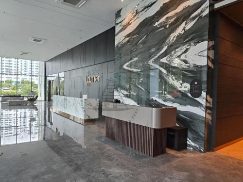 a lobby with a large painting on the wall at AFFT Home Camp - Kota Kinabalu Seaview in Kota Kinabalu