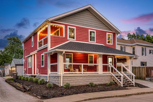 a red house with a gambrel at Indy Getaway - 5BR - Sleeps 16 - Arcade games - Perfect for families and groups in Indianapolis