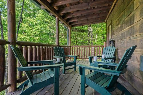 three chairs sitting on the porch of a cabin at Serenity Escape in Sevierville