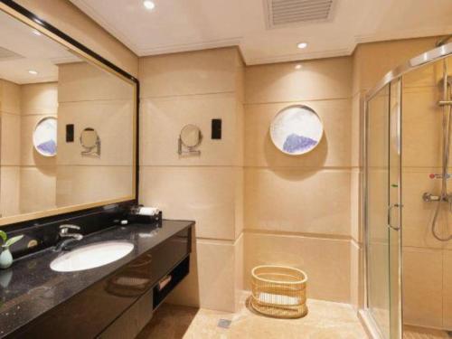a bathroom with a sink and a shower at Fuzhou Xin Zi Yang Hotel in Fuzhou