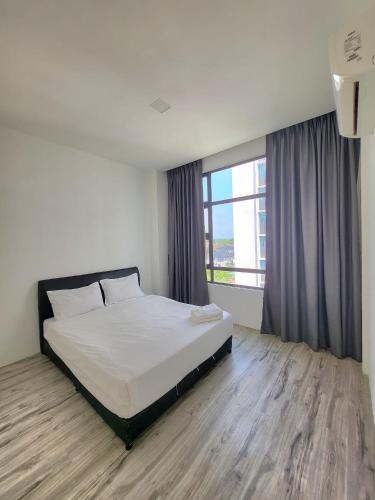 a bedroom with a bed and a large window at Zen66 @ Roxy Serviced Apartment in Kuching