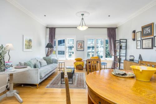 a living room with a couch and a table at Central Apt with Art Gallery Views and FREE Parking in Auckland